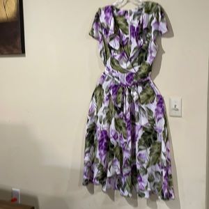 Flare long back, slight short front cap sleeve, frill around neck.